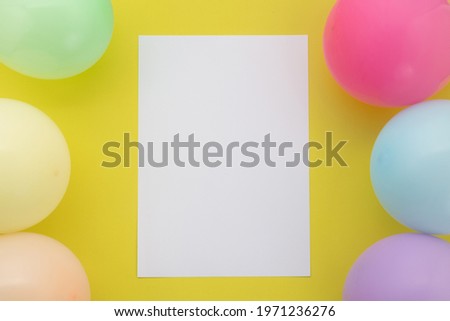 Happy birthday background, Flat lay colorful party decoration with flyer invitation card on pastel yellow background.