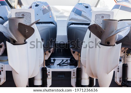 Motor propellers for motor yachts and boats close-up. The motors are installed at the stern of the boat. The outboard motors at the stern of the boat are raised. Royalty-Free Stock Photo #1971236636