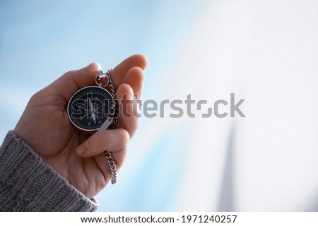 Travel concept. Magnetic compass in the hand. Retro navigator in hand map and airplane background. Adventure Background.