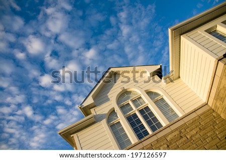 A building under a cloudy blue sky during the day.