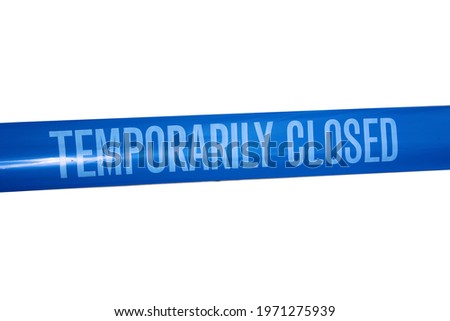 Temporarily closed caution tape. Closed due to Covid-19. Information notice sign about quarantine measures. Close up on a closed caution tape. Blue and White Tape Sign isolated on white. Royalty-Free Stock Photo #1971275939