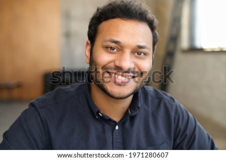 Cheerful and serene hindu man in smart casual shirt, headshot of young handsome indian guy, handsome mixed-race male looks at the camera with toothy smile Royalty-Free Stock Photo #1971280607