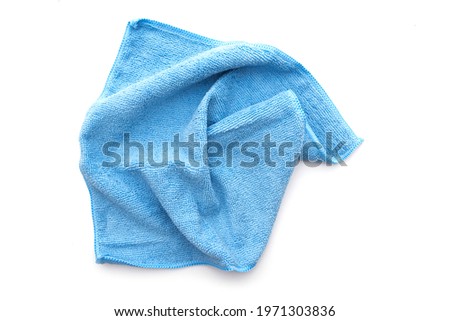 Blue kitchen rug isolated on white. Crumpled used micrifibre cloth clean, top view.  Royalty-Free Stock Photo #1971303836