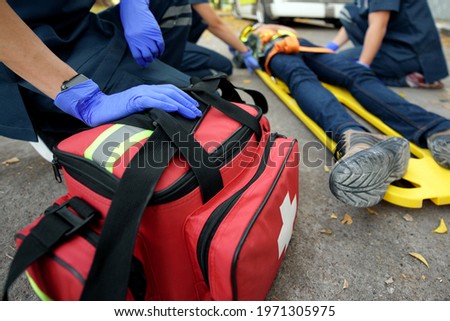 Emergency Medical First aid kit bags of first aid team service for an accident in work of worker loss of function in limbs, First aid training to transfer patient Royalty-Free Stock Photo #1971305975