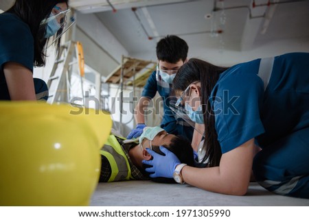 Emergency Medical First aid for head injuries of worker accident in work, Loss of feeling or loss of normal movement and Loss of function in limbs, First aid training to transfer patient. Royalty-Free Stock Photo #1971305990