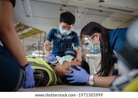 Emergency Medical First aid for head injuries of worker accident in work, Loss of feeling or loss of normal movement and Loss of function in limbs, First aid training to transfer patient. Royalty-Free Stock Photo #1971305999