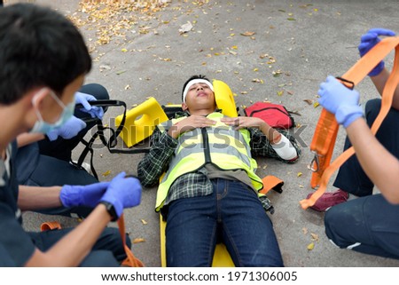 Emergency Medical First aid for head injuries of worker accident in work, Loss of feeling or loss of normal movement and Loss of function in limbs, First aid training to transfer patient. Royalty-Free Stock Photo #1971306005