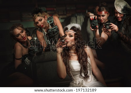 Photographers is taking a picture of a beautiful cabaret girls