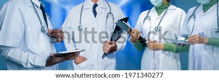 Medicine doctors team standing with tablet and file and clipboard in hospital background. 
