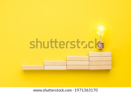 abstract business strategy concept. steps to idea symbol shown as light bulb over yellow background. inspiration and innovation conceptual.