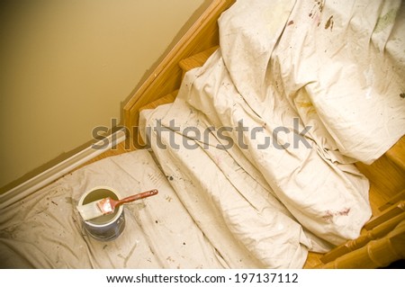 A can of paint on top of a drop cloth. Royalty-Free Stock Photo #197137112