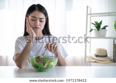 Asian woman feel anorexia, The girl does not like to eat vegetables, Healthy food. Royalty-Free Stock Photo #1971378422