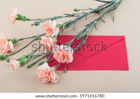Beautiful fresh blooming orange color tender carnations with card