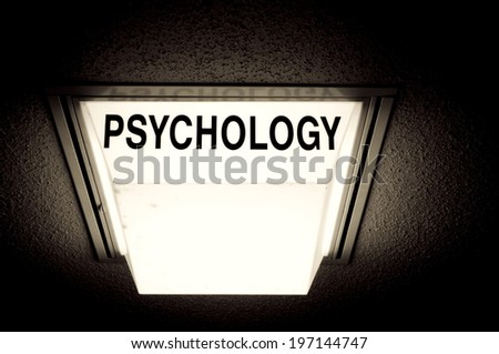 A light against a rough surface with the word psychology on it.