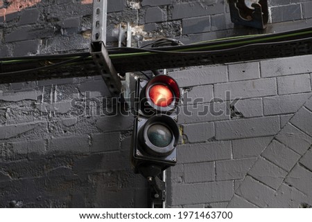 An old traffic light against the wall