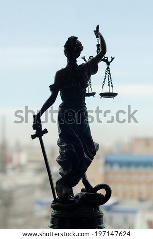 on city outdoors blue sky copy space background picture of back of sculpture of themis, femida or justice goddess 
