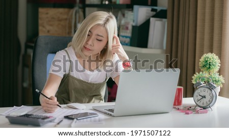 Women are working with information papers on the home desk.