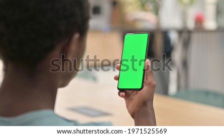 African Man Using Smartphone with Green Chroma Screen