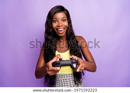 Photo of crazy funny dark skin lady enjoy playing game have good mood isolated on violet color background