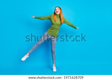 Full length body size view of attractive cheerful girl jumping having fun isolated over bright blue color background