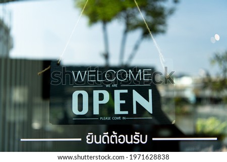 Hanging signs in restaurants, The restaurant is open for normal service and There is the word "Welcome" in Thai below.