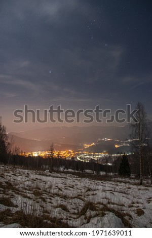 Beautiful panorama of the night city in the Carpathian mountains in winter