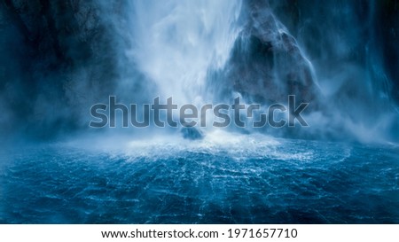 Stirling Falls plunging vertically over the cliff into Milford Sound, fanning out at its base in circular ripples on the surface of the water, New Zealand Royalty-Free Stock Photo #1971657710