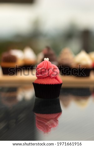 cupcake on glass table, reflections, space for writing
