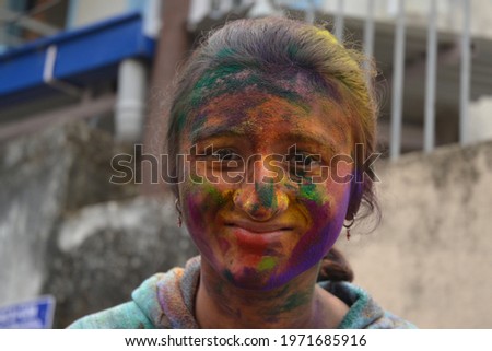 Close-up picture of an indian girl after playing holi, a traditional festival of colours.