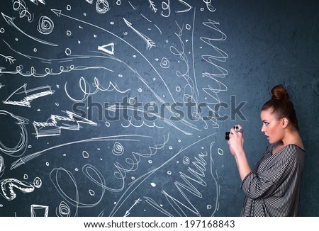 Photographer girl shooting images while energetic hand drawn lines and doodles come out of the camera