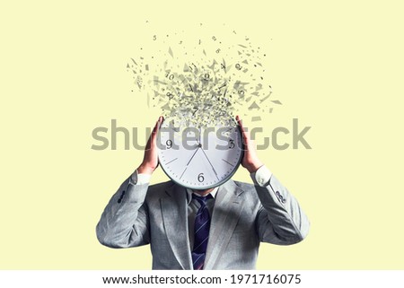 Businessman with a disintegrating clock instead of a head. Dispersion effect. Lack of time. Waste of time. Business. Lifestyle. Background Royalty-Free Stock Photo #1971716075
