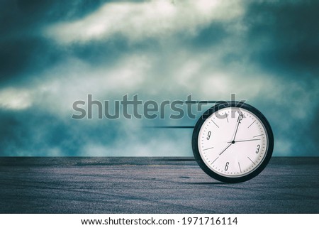 Clock in a car wheel, rolls along the road. Time concept. Business. Lifestyle. Background.
