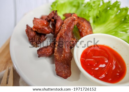Fried Sun Deaw Pork Served with chili sauce and vegetable , a quick appetizer is delicious.