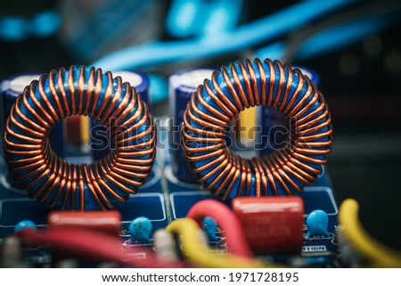 Close up of inductor copper coil on circuit board Royalty-Free Stock Photo #1971728195