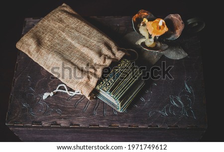  A fortune teller, witch stuff on a table, candles and fortune-telling objects. The concept of divination, astrology and esotericism Royalty-Free Stock Photo #1971749612