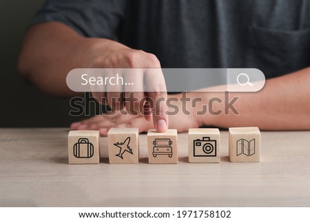 online travel concept with travel icons on wooden block background,with search bar.using Search Console with your website.