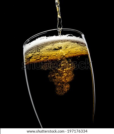 beer poured into a glass on a black background Royalty-Free Stock Photo #197176334