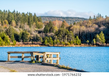 Spruce Knob Lake in West Virginia at sunset with nobody at overlook with blue water and forest pine trees autumn fall season landscape view