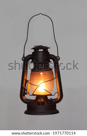 old vintage rusty kerosene black lamp isoleted on gray background. Glass oil lamp. Storm lantern. object vintage concept Royalty-Free Stock Photo #1971770114