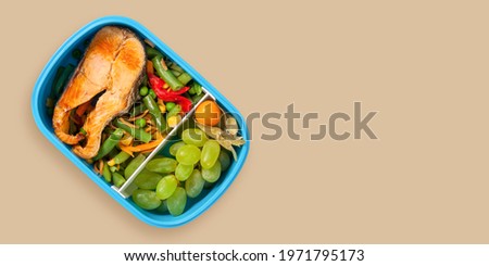 Healthy Meal lunch box containers with grilled salmon fish and vegetables on color background. Top view. Banner. Copy space
