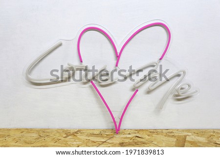 White and pink neon heart with the inscription love me. Trendy style. Wedding design.
 Neon sign. Custom neon. Home decor. 