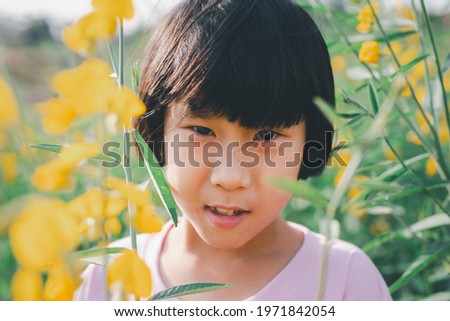 Portrait, little girl in flower field outdoor
