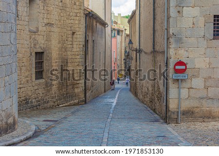 Historical part of the old town in the vicinity of the Church of St. Philip (Girona, Spain). Stock photo.