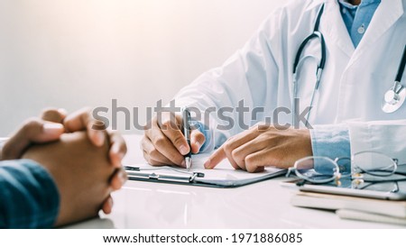 close up of patient and doctor taking notes,Health consultation. Royalty-Free Stock Photo #1971886085