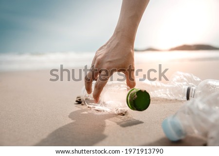Environment, Ecology Care, Renewable Concept. Volunteer or Traveller Collecting Plastic Bottle Waste on the Beach Sand. Keep Beach Clean Royalty-Free Stock Photo #1971913790