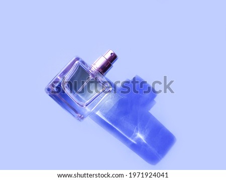bottle of perfume on a colored background shadow
 Royalty-Free Stock Photo #1971924041