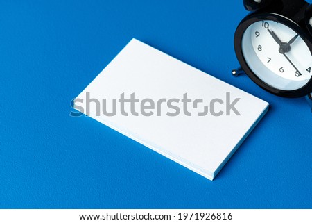 Mock up businesscard with black alarm clock