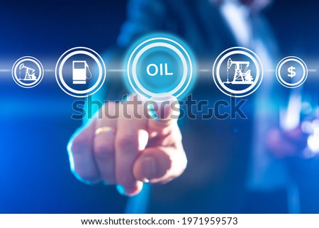 Oil trading concept. Trader holds out his finger to inscription oil. Foreground oil icons. Crude petroleum buying and selling business. Blurred hand of a trader close up. Petroleum industry
