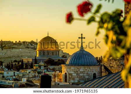 The dome of a Christian church and the dome of the rock in the setting sun Royalty-Free Stock Photo #1971965135