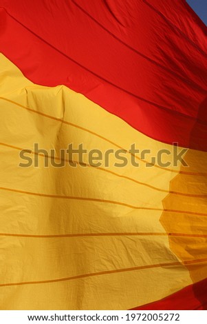red and yellow sail of a boat